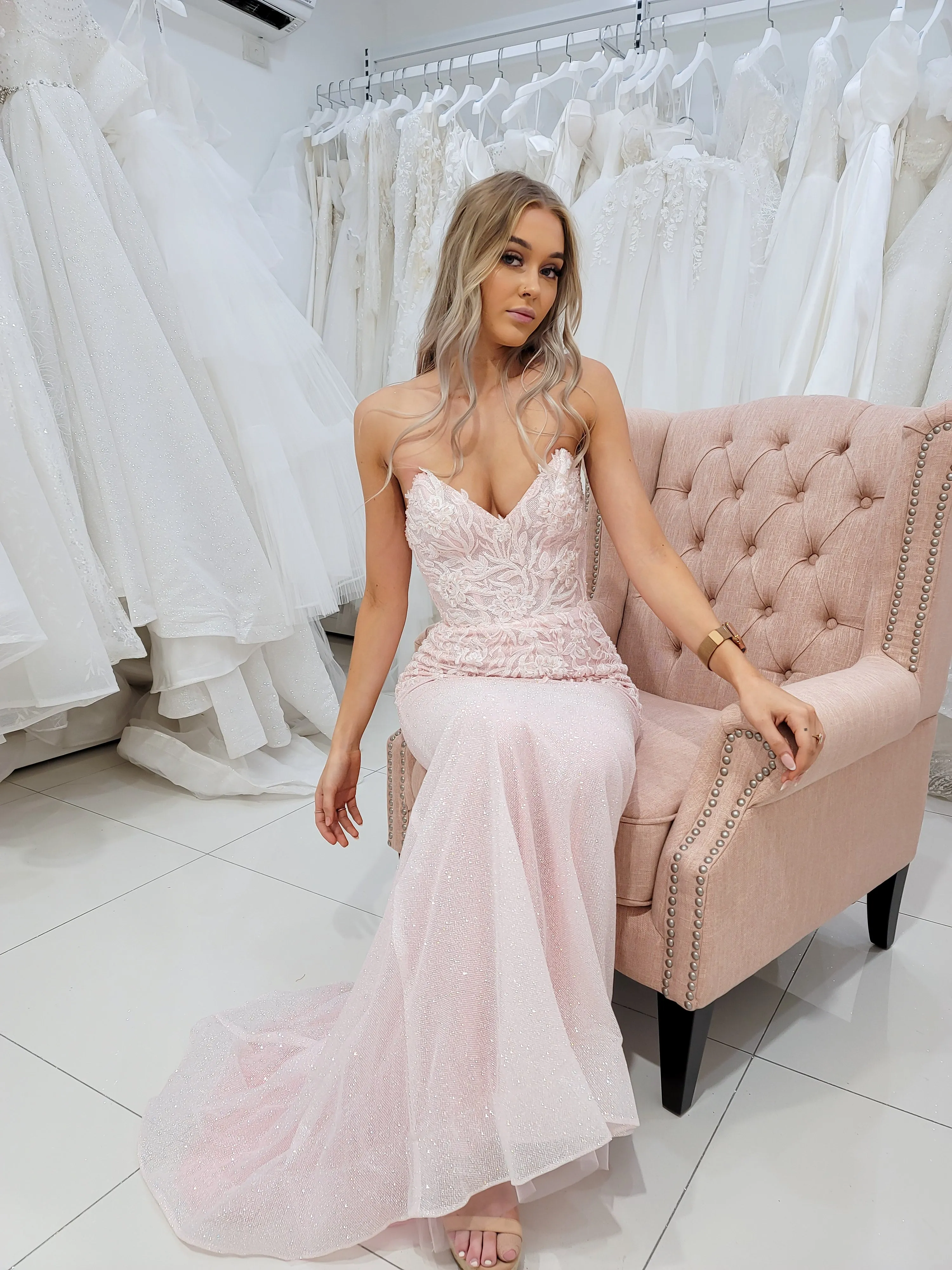 Sparkling pink dress with strapless deep V neckline and corset back fore hire.