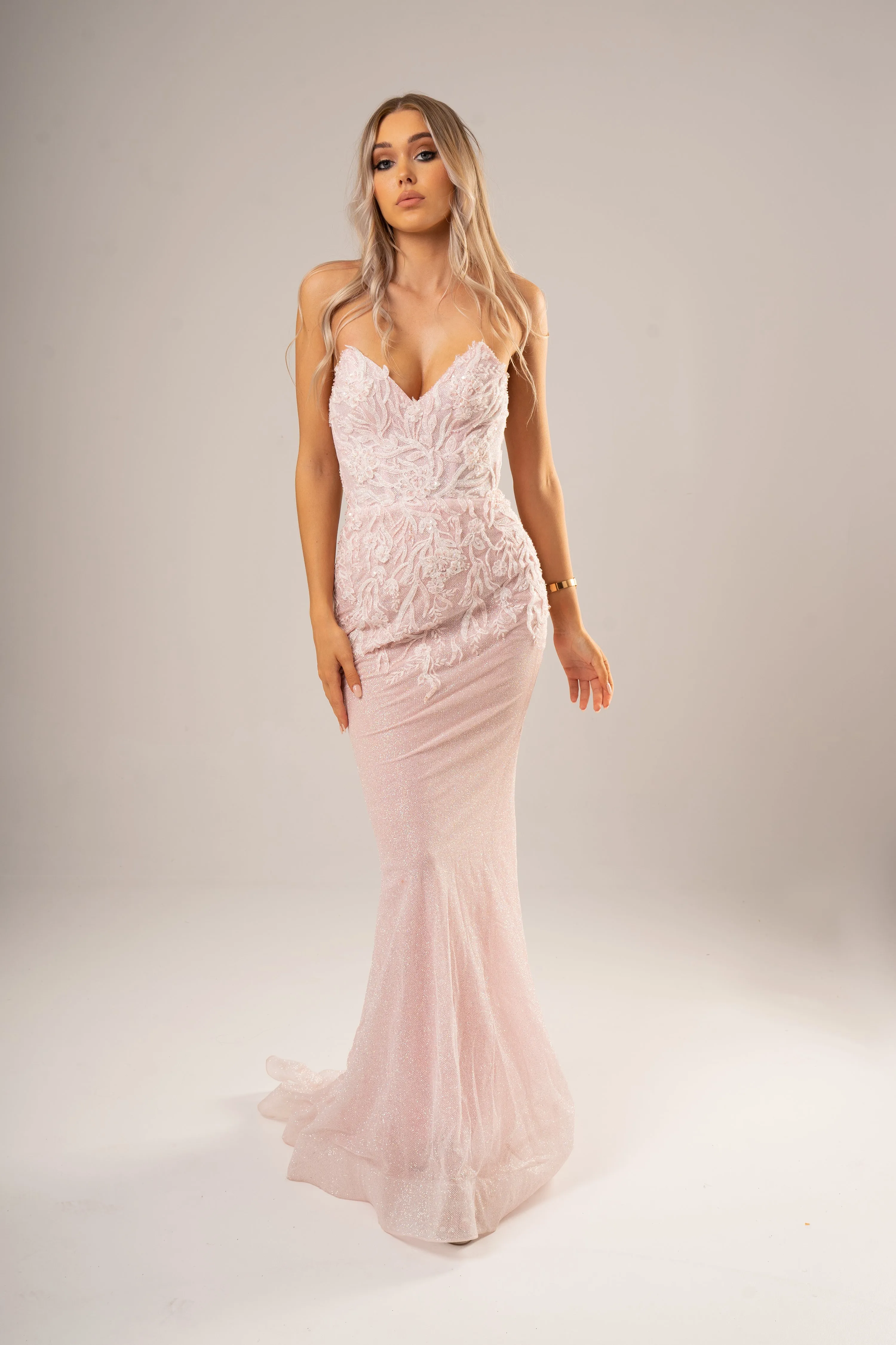 Sparkling pink dress with strapless deep V neckline and corset back fore hire.